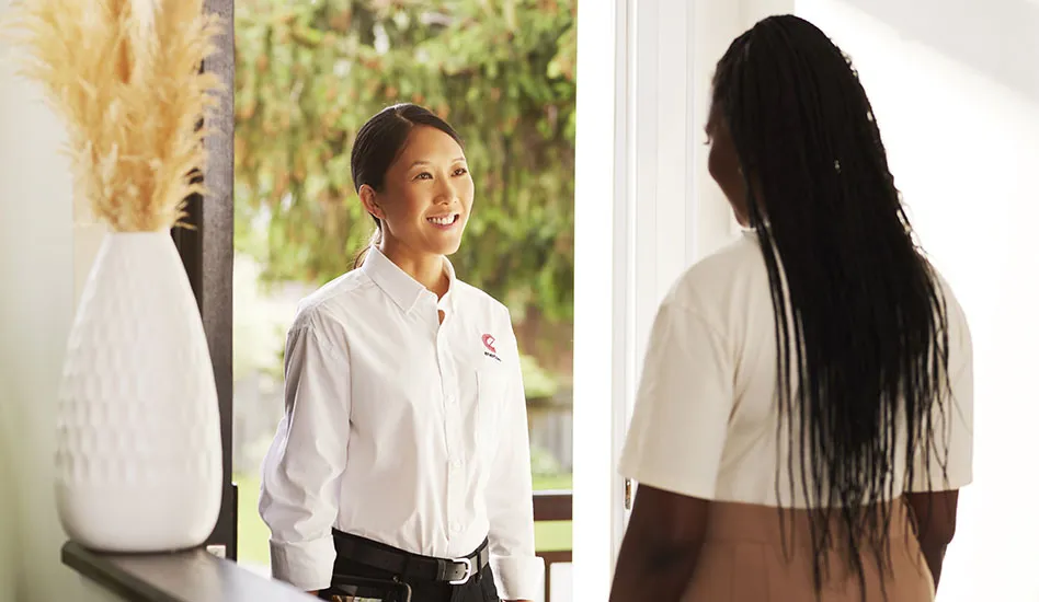woman greeting technician at the door